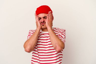 Beyaz arka planda ağlayan ve sızlanan beyaz tenli genç bir adam var..