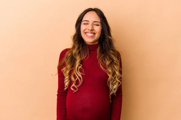 Young Mexican Pregnant Woman Isolated Beige Background Laughs Closes Eyes — Stock Photo, Image