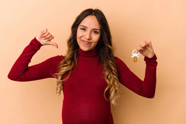 Young Mexican Pregnant Woman Holding Pacifier Isolated Beige Background Feels — Stock Photo, Image