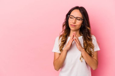 Pembe arka planda izole edilmiş genç Meksikalı bir kadın..