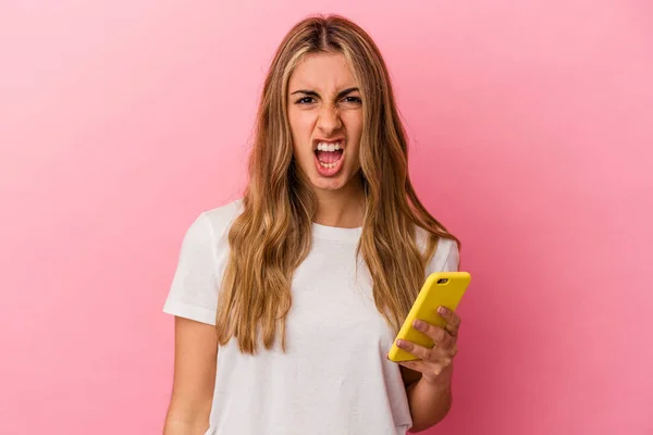Young Blonde Caucasian Woman Holding Yellow Mobile Phone Isolated Screaming — Stock Photo, Image