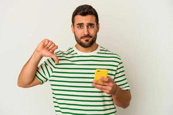 Young Caucasian Man Holding Mobile Phone Isolated White Background Showing — Stock Photo, Image