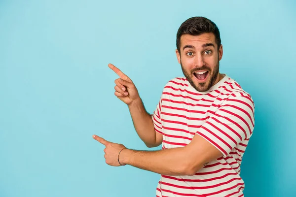 Young Caucasian Man Isolated Blue Background Excited Pointing Forefingers Away — Stock Photo, Image