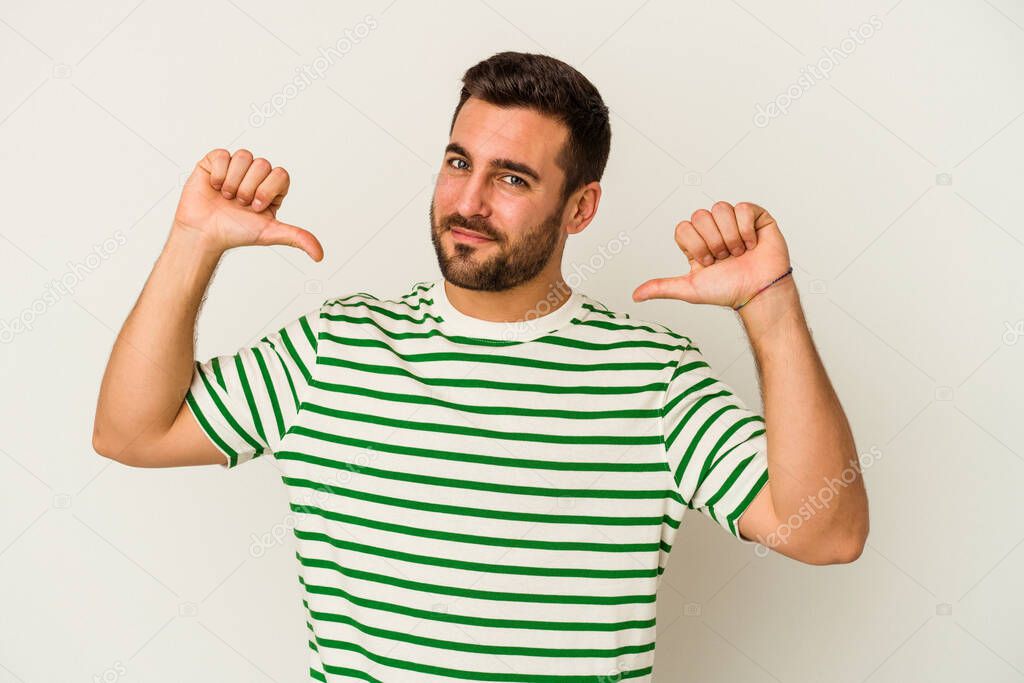 Young caucasian man isolated on white background feels proud and self confident, example to follow.