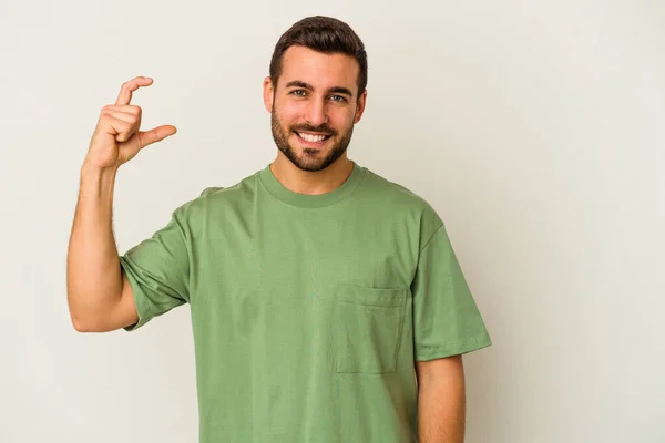 Young Caucasian Man Isolated White Background Holding Something Little Forefingers — Stock Photo, Image