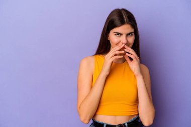 Kafkasyalı genç bir kadın mor arka planda izole edilmiş bir plan yapıyor, bir fikir kuruyor..