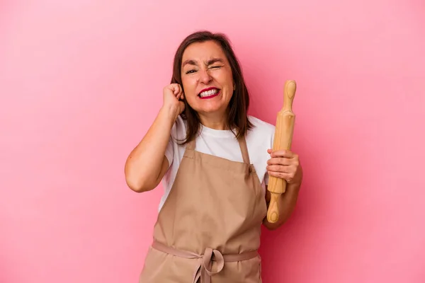 Mulher Chef Pastelaria Meia Idade Isolado Fundo Rosa Cobrindo Orelhas — Fotografia de Stock