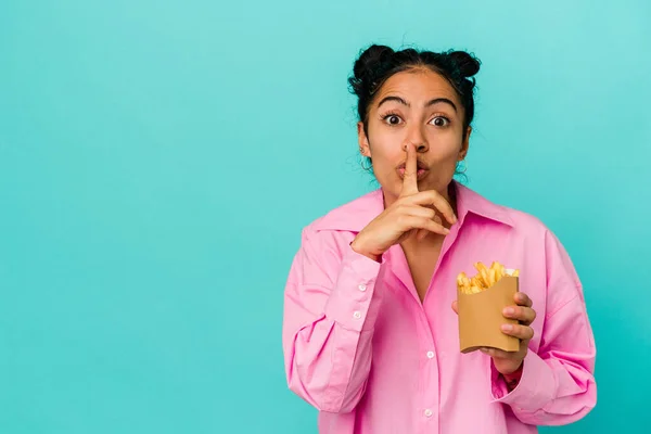 Young Latin Woman Holding Chips Isolated Blue Background Keeping Secret — Stock Photo, Image