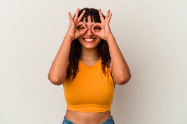 Beyaz arka planda izole edilmiş genç melez kadın gözlerde sorun olmadığını gösteriyor.