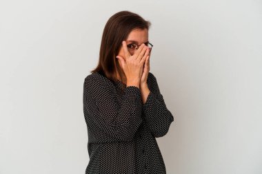 Beyaz arka planda izole edilmiş orta yaşlı beyaz kadın korkmuş ve gergin parmaklarıyla göz kırp..