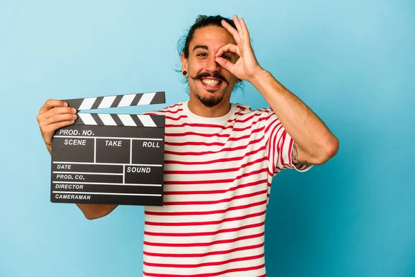 Young Caucasian Man Long Hair Holding Clapperboard Isolated Blue Background — Stock Photo, Image