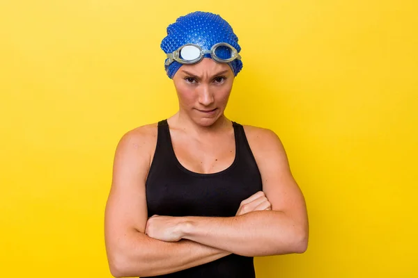 年轻的澳大利亚游泳女子在黄色背景下孤立无援 愁眉苦脸 两臂交叉 — 图库照片