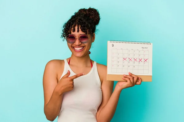 Jovem Mista Segurando Calendário Isolado Fundo Azul Sorrindo Apontando Para — Fotografia de Stock