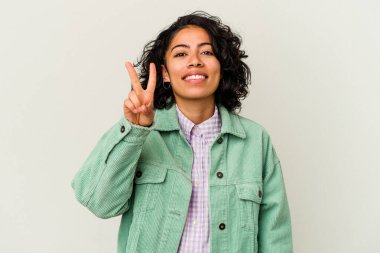 Beyaz arka planda izole edilmiş genç kıvırcık Latin kadın iki numarayı parmaklarıyla gösteriyor..