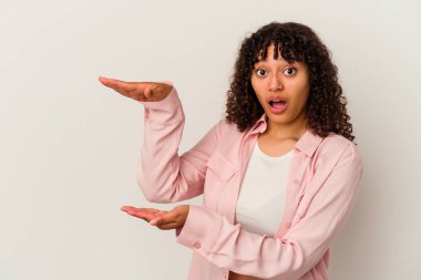 Beyaz arka planda izole edilmiş genç bir ırk kadını elleri arasında bir kopya alanı tutarken şok ve şaşkınlık yaşadı..