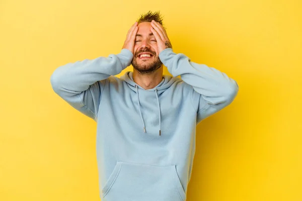 Young Tattooed Caucasian Man Isolated Yellow Background Laughs Joyfully Keeping — Stock Photo, Image