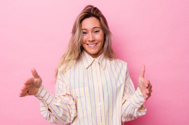 Avustralyalı genç bir kadın iki eliyle bir şey tutuyor..