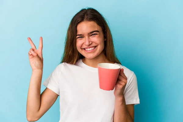 Joven Mujer Caucásica Sosteniendo Una Taza Aislada Sobre Fondo Azul —  Fotos de Stock