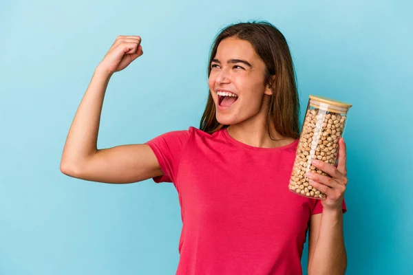 Young Caucasian Man Holding Chickpeas Jar Isolated White Background Raising — Stock Photo, Image