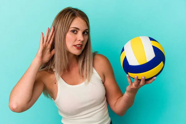 Jovem Russa Jogando Vôlei Isolado Fundo Azul Tentando Ouvir Uma — Fotografia de Stock