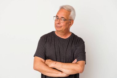 Beyaz arka planda izole edilmiş yaşlı Amerikalı adam alaycı bir ifadeyle kameraya bakıyor..