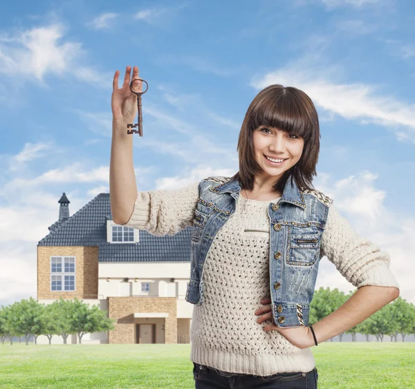 Young woman holding old key — Stock Photo, Image