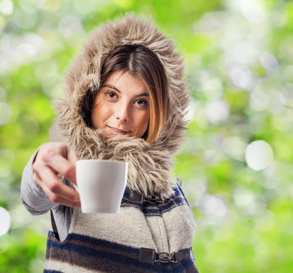 Young woman offering cup of coffee — Stock Photo, Image