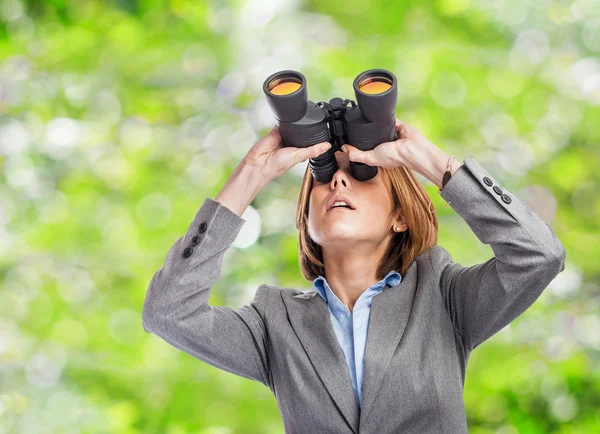 Executive young woman with binoculars — Stock Photo, Image