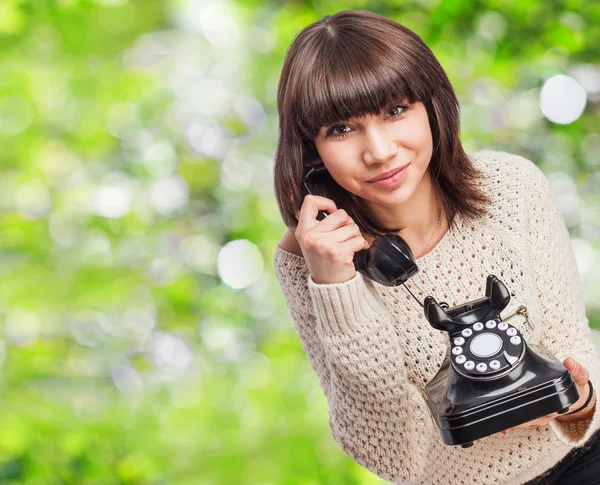 Pretty young woman talking on telephone — Stock Photo, Image