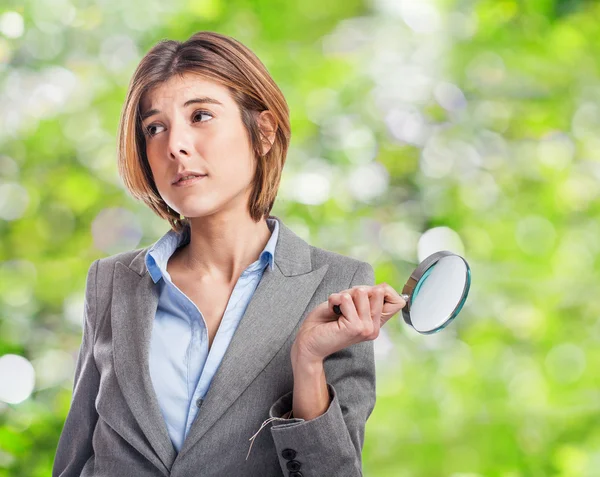 Woman holding magnifying glass — Stock Photo, Image