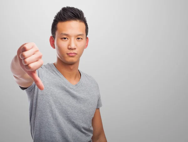 Asian man doing negative gesture — Stock Photo, Image