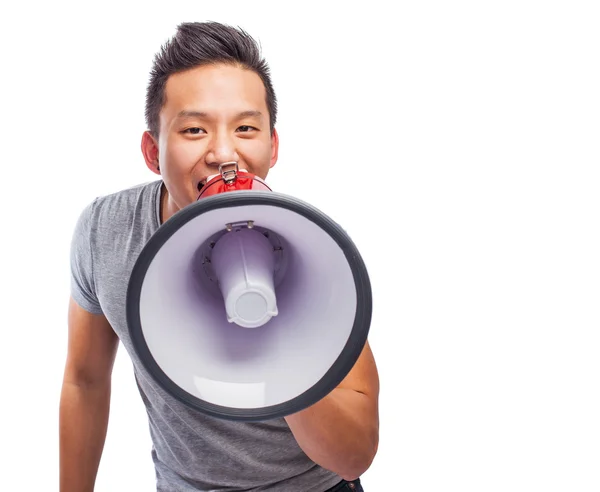 Молодой азиат с мегафоном — стоковое фото