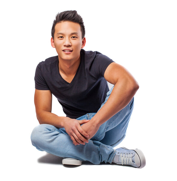Young asian man sitting on floor