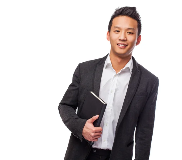 Joven asiático hombre holding libro — Foto de Stock