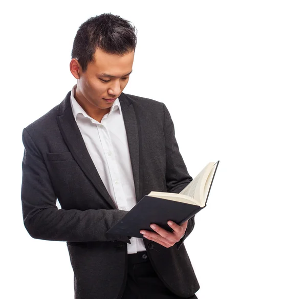 Jonge Aziatische man bedrijf boek — Stockfoto