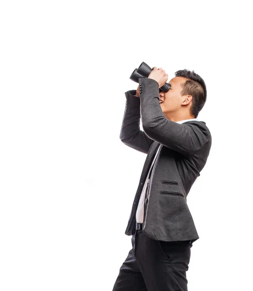 Businessman looking trough binoculars — Stock Photo, Image