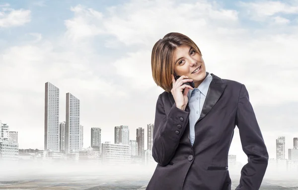 Executive young woman talking on telephone — Stock Photo, Image
