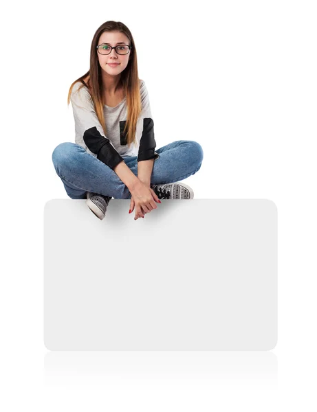 Young woman sitting on box — Stock Photo, Image