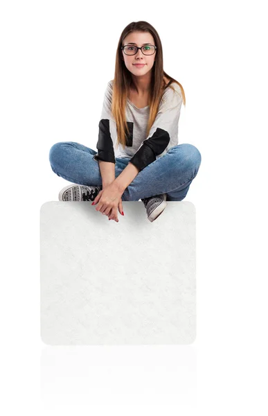 Young woman sitting on box — Stock Photo, Image