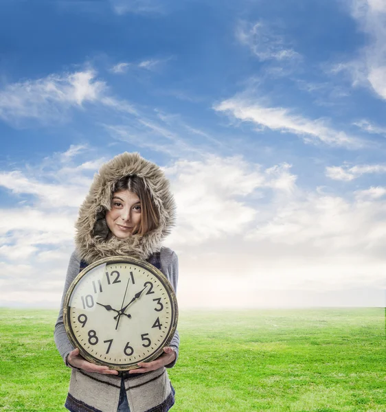 Young pretty woman holding clock — Stock Photo, Image