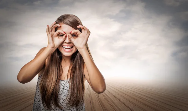 Young woman doing glasses sign — Stock Photo, Image