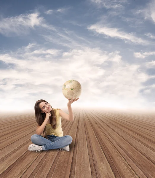 Young woman looking at globe — Stock Photo, Image