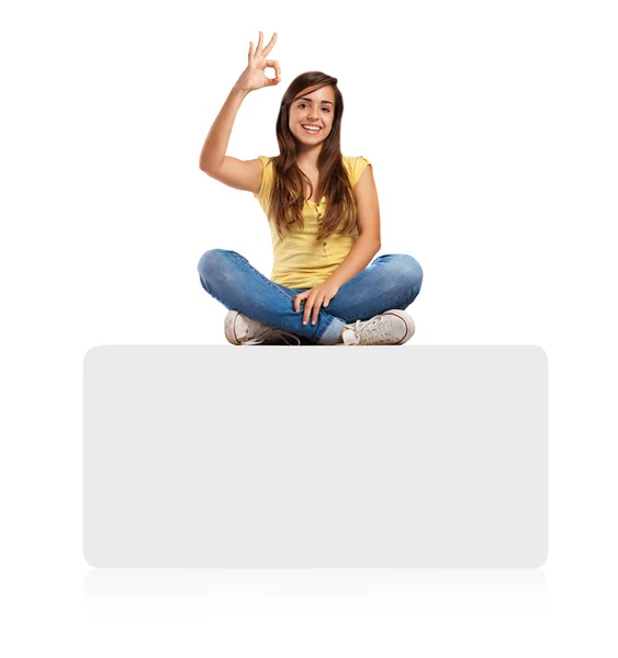 Young woman sitting on banner — Stock Photo, Image