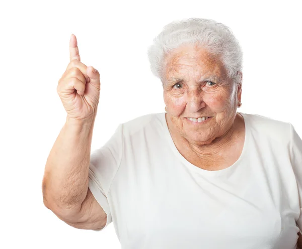 Stara kobieta skierowana w górę z palca — Zdjęcie stockowe