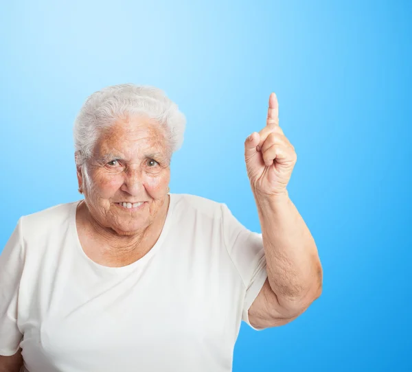 Stara kobieta skierowana w górę z palca — Zdjęcie stockowe
