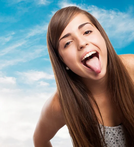 Funny young girl showing tongue — Stock Photo, Image