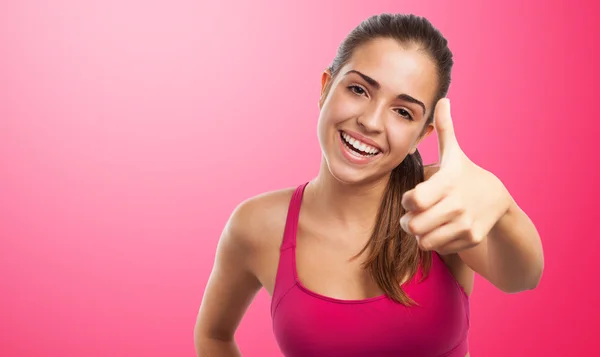 Sporty girl doing positive gesture — Stock Photo, Image