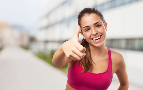 Sporty girl doing positive gesture — Stock Photo, Image