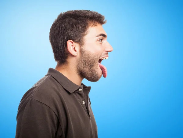 Bonito homem mostrando sua língua — Fotografia de Stock