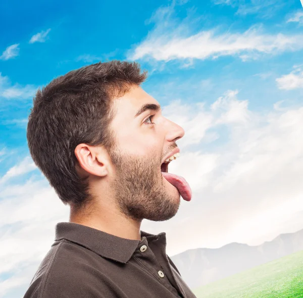 Handsome man showing his tongue — Stock Photo, Image